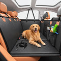 Golden retriever lying on a black dog car back seat cover with storage pockets