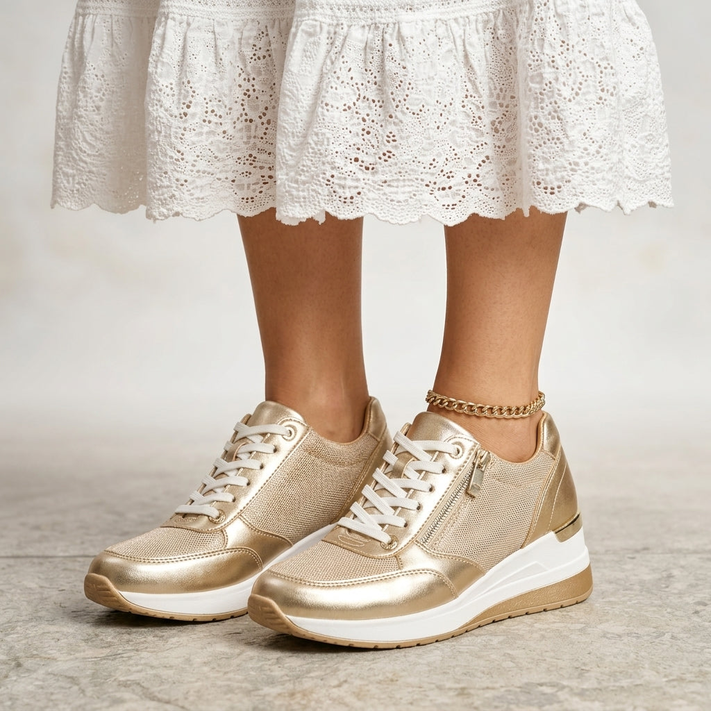 Pair of gold leather platform sneakers with white laces and side zip, front view