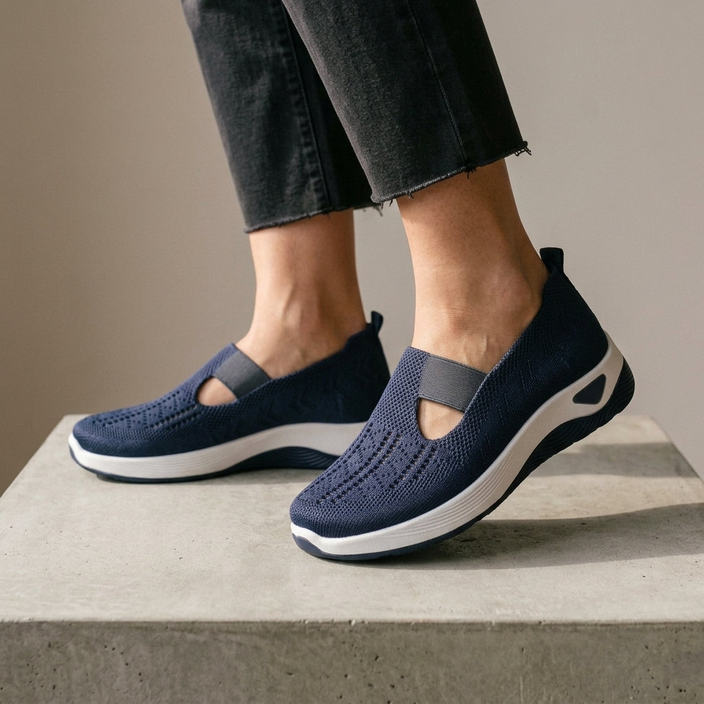 Dark Blue mesh knit sneakers worn with grey cropped jeans.