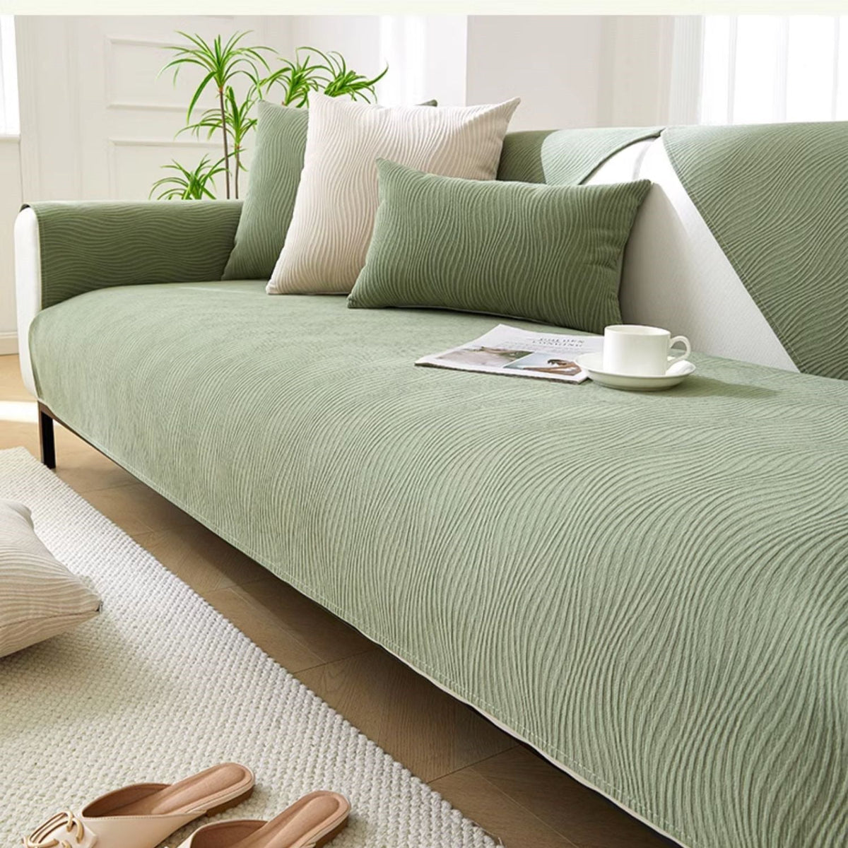 Green textured fabric sofa cover on a sofa in a minimalist living room