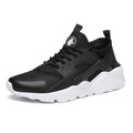 Women's black mesh sneakers with a white sole, shown from the side.