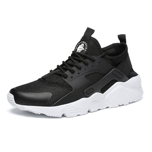 Women's black mesh sneakers with a white sole, shown from the side.