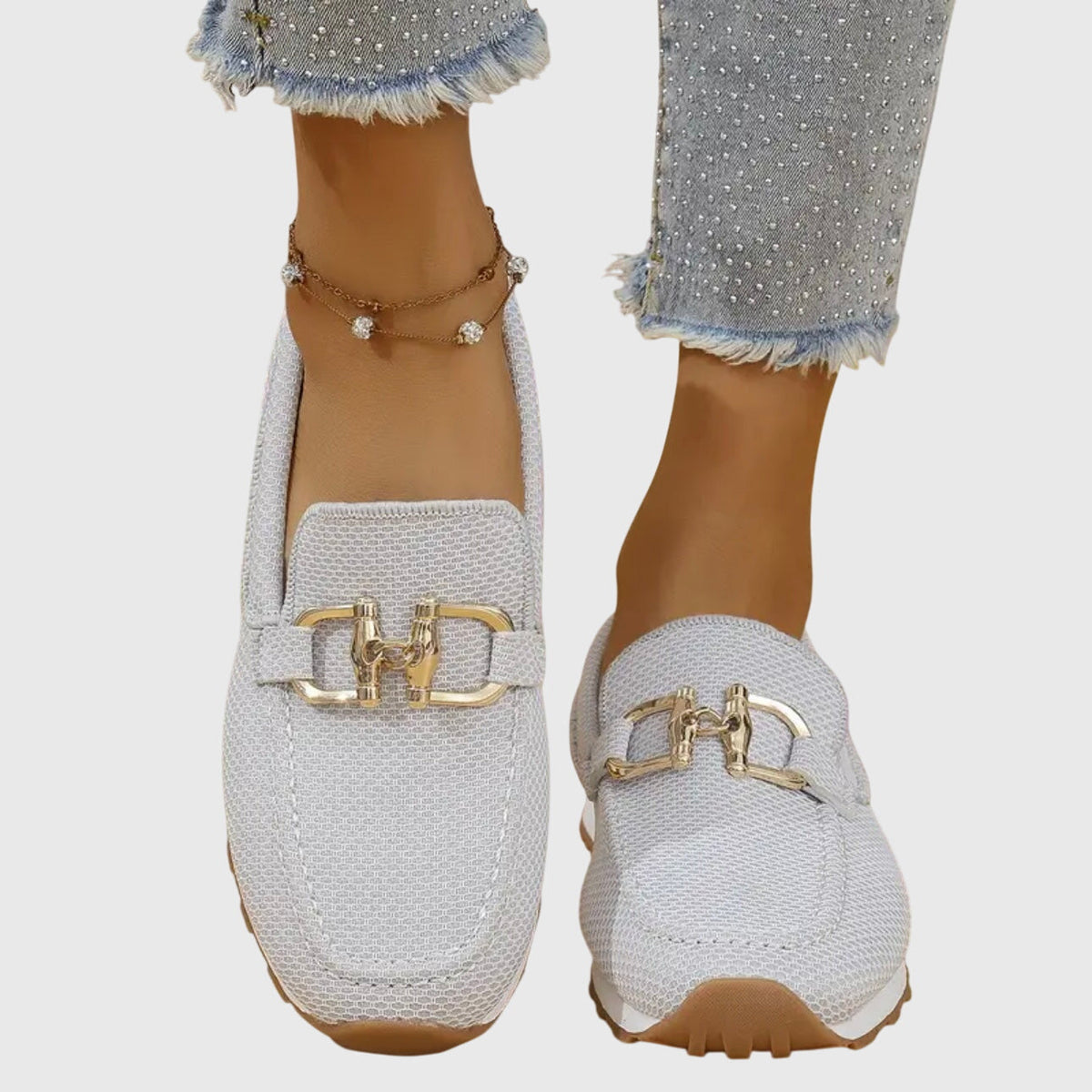 Front view of white mesh loafer trainers with gold-tone detail and white sole