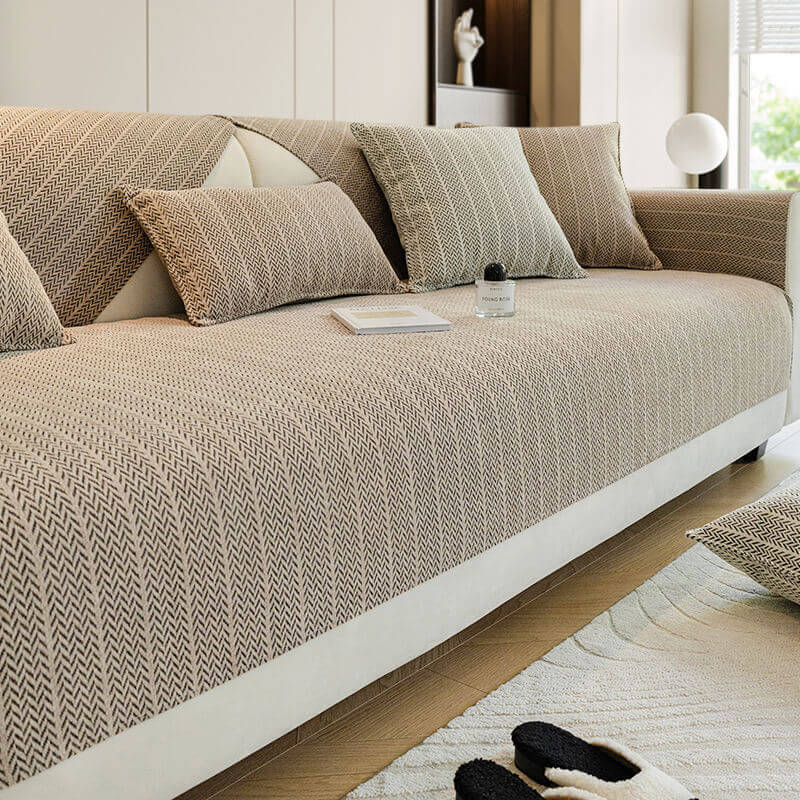 Khaki herringbone woven sofa cover with matching cushion covers in a living room