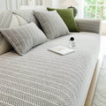 Light grey herringbone sofa cover on a cream sofa with matching cushions