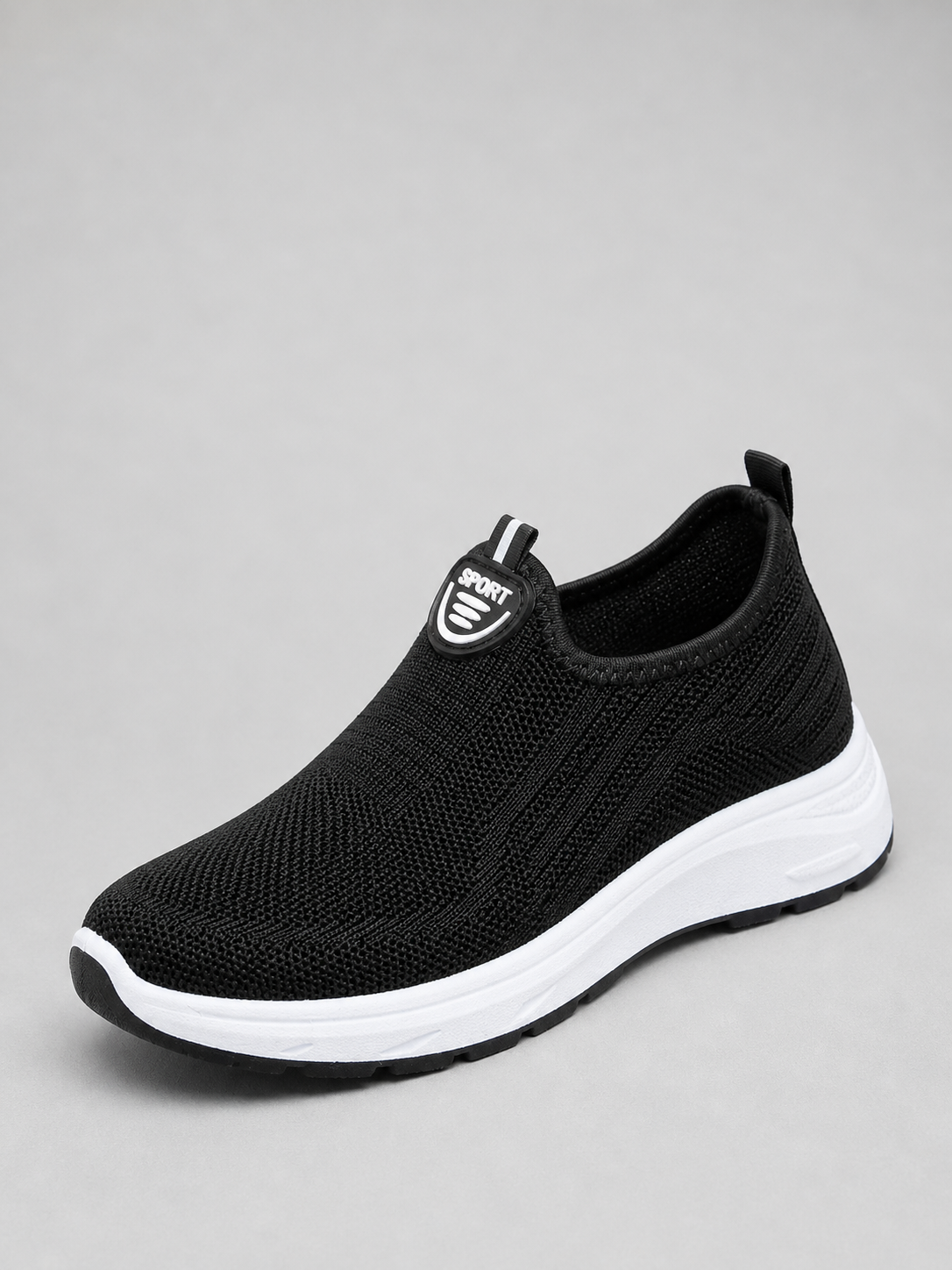 Black slip-on knit trainer with a white sole