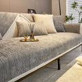 Grey woven sofa cover with fine texture and cream trim, styled with cushions and a gold-tone tray
