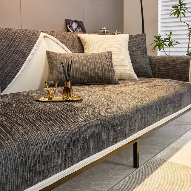 Dark grey woven fabric sofa cover with cream edge trim on a modern sofa