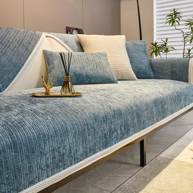 Blue woven fabric sofa cover with cream edge trim and matching cushion covers