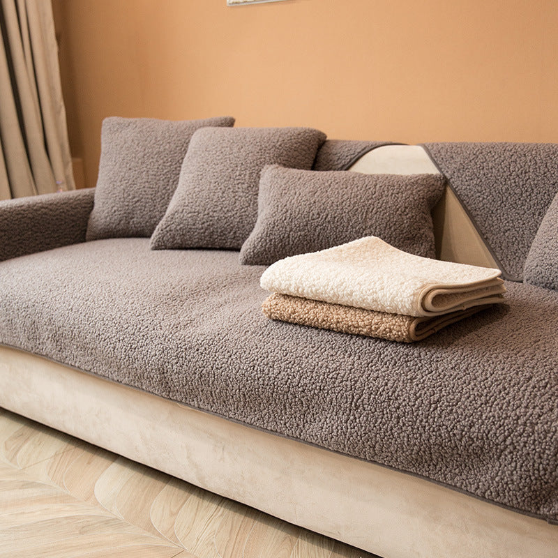 Dark grey plush teddy sofa cover with cushion covers in a living room