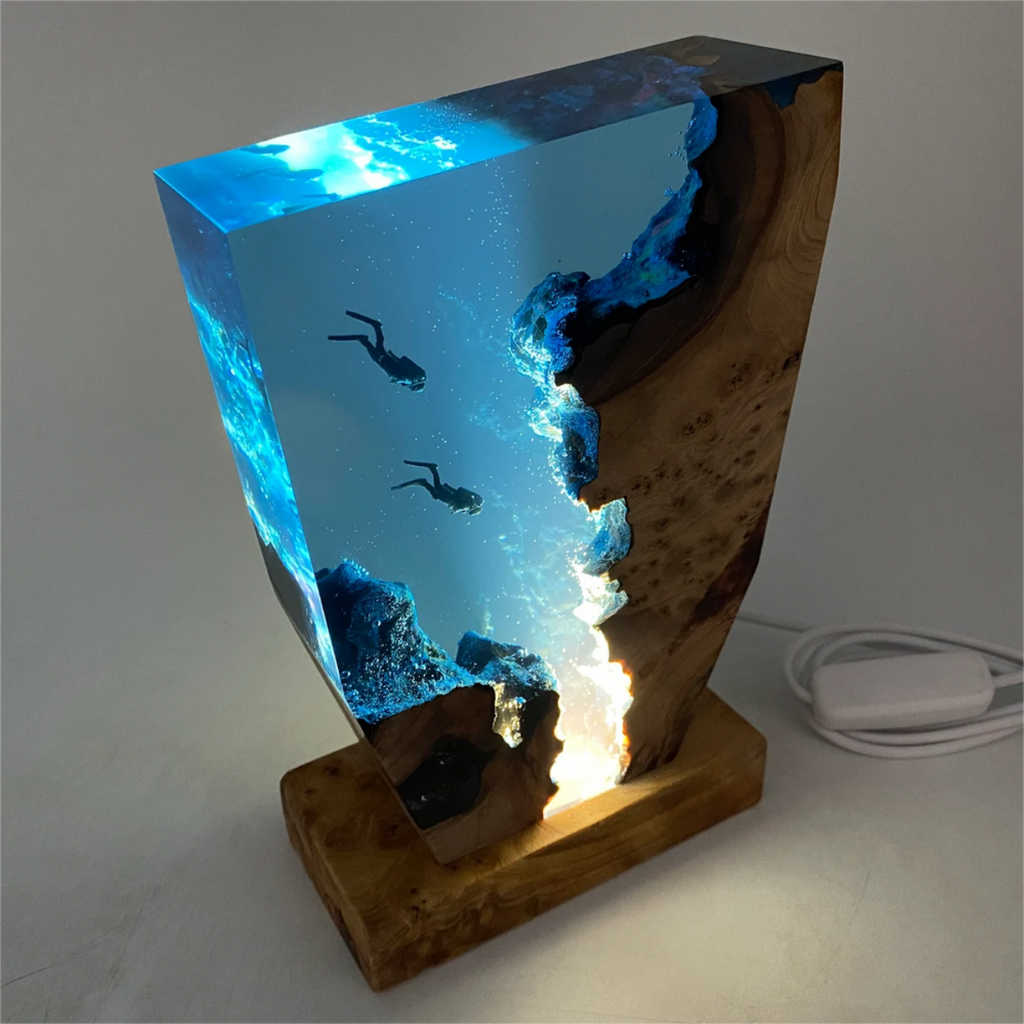 Wooden ocean diver table lamp seen from the other side with lit blue panel