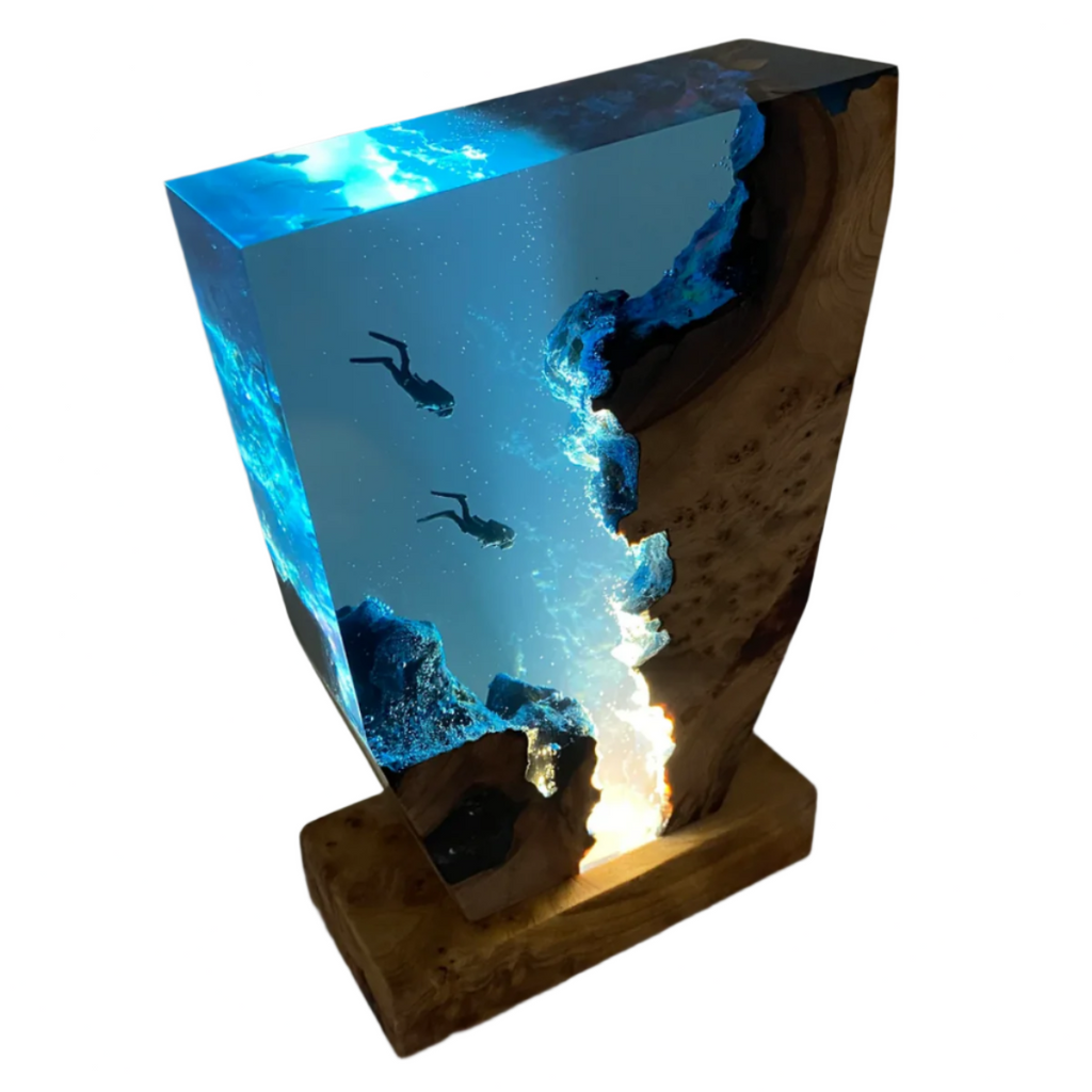 Top-down angled view of wooden LED lamp with transparent blue panel and diver scene
