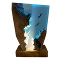 Wooden LED table lamp with ocean diver scene lit up on a white background