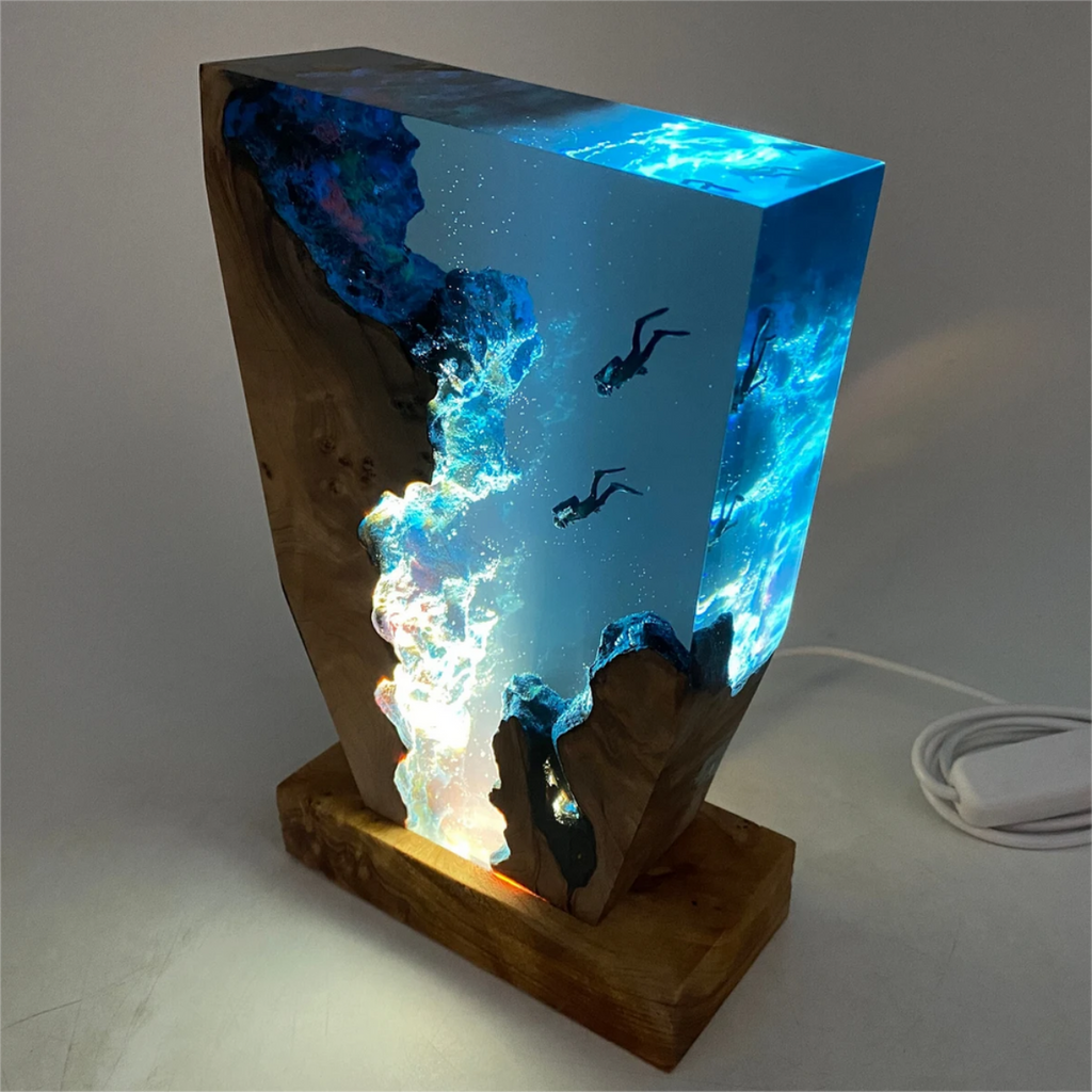 Angled view of decorative wooden table lamp with glowing blue panel and cable with switch