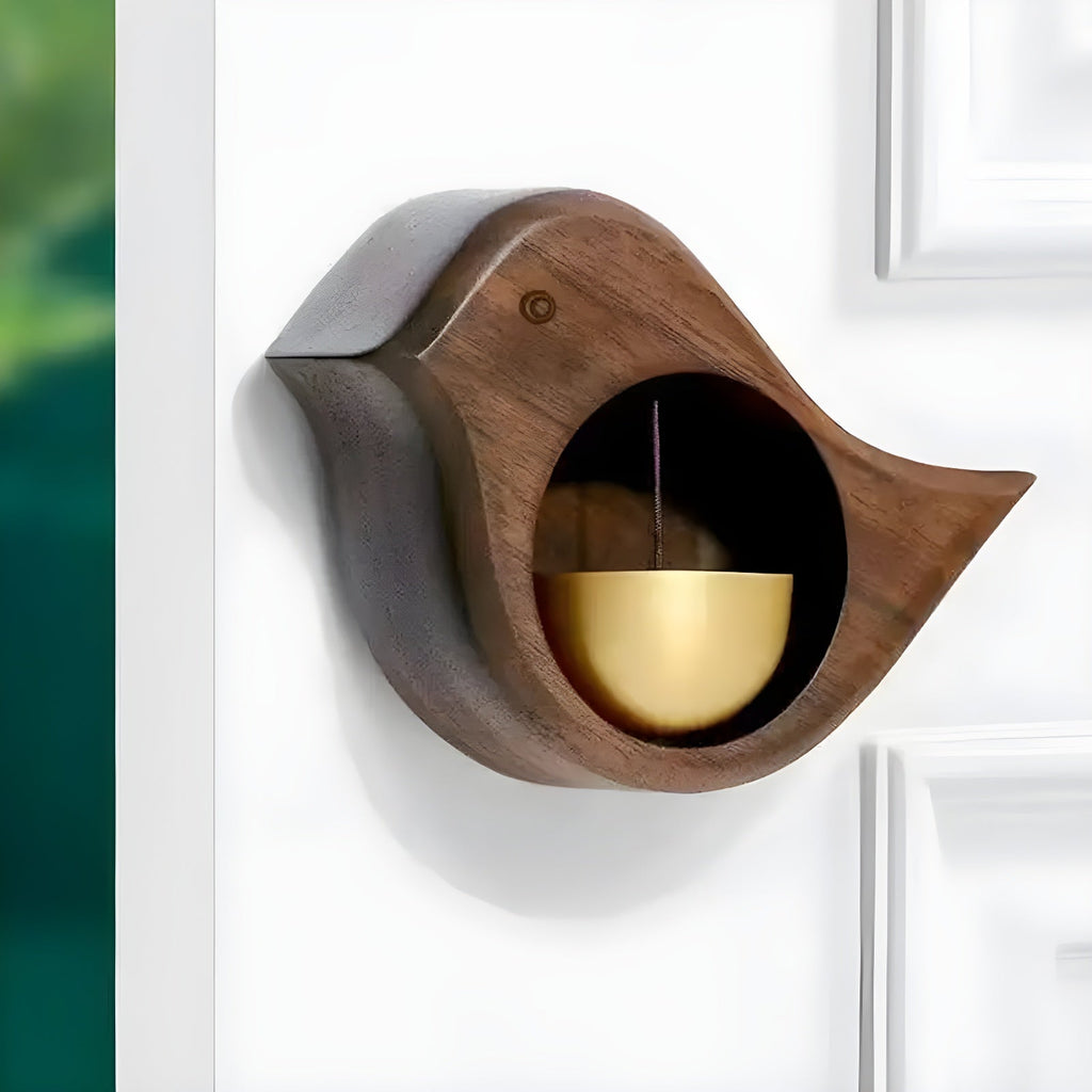 Brown wood-effect bird door bell with gold-tone bell fitted to a white door