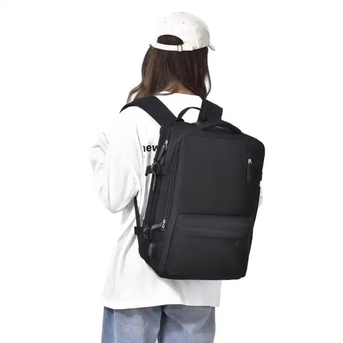 Person wearing black multi-compartment backpack, rear view
