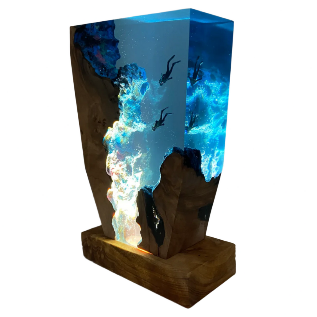 Decorative wooden table lamp with rectangular base and glowing ocean scene