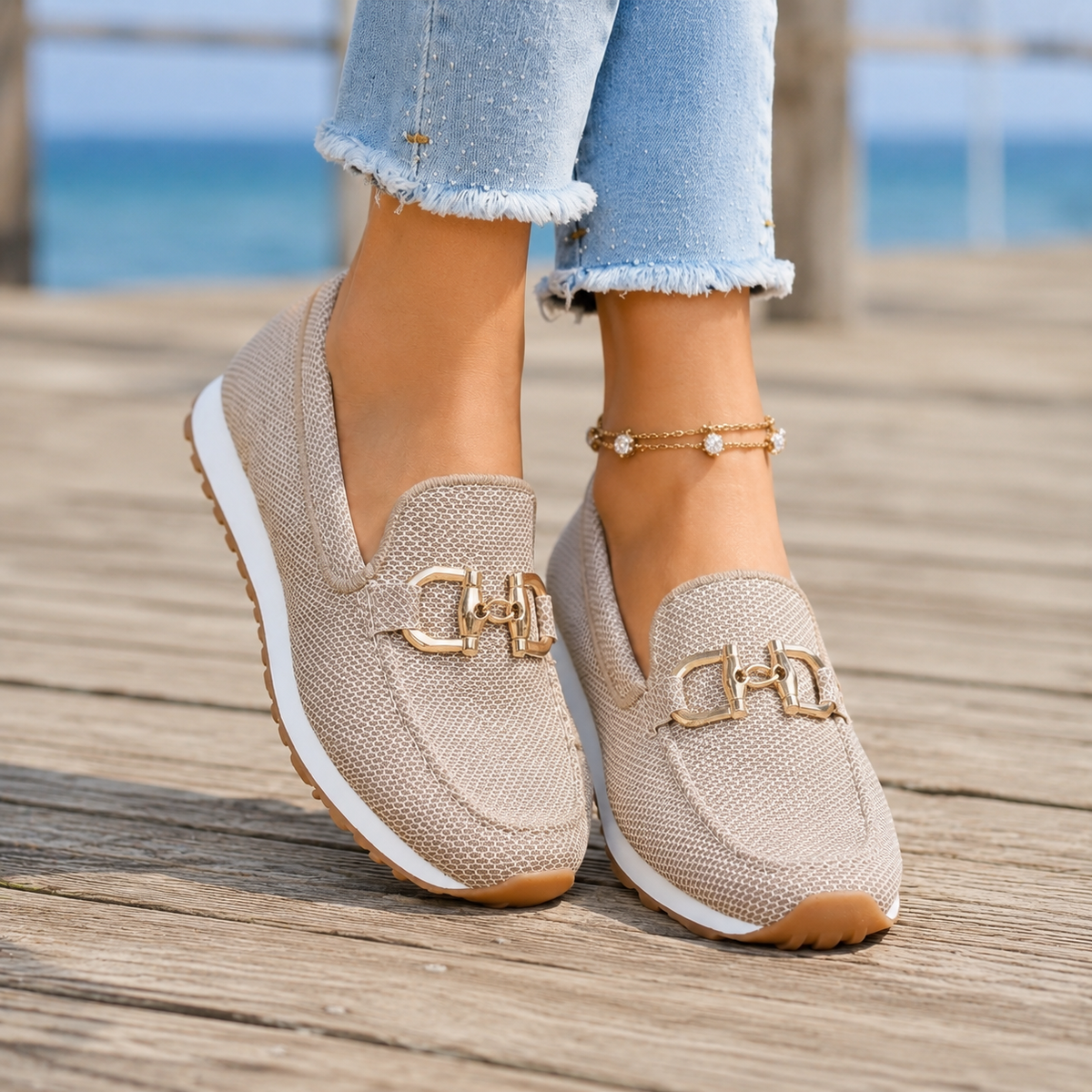 Beige women's slip-on loafer trainers, gold-tone detail loafer trainers with a woven upper, worn with cropped jeans