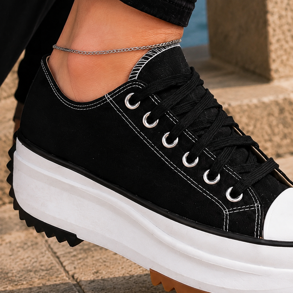 Black lace-up low-top platform trainers with a chunky platform sole and deep serrated tread