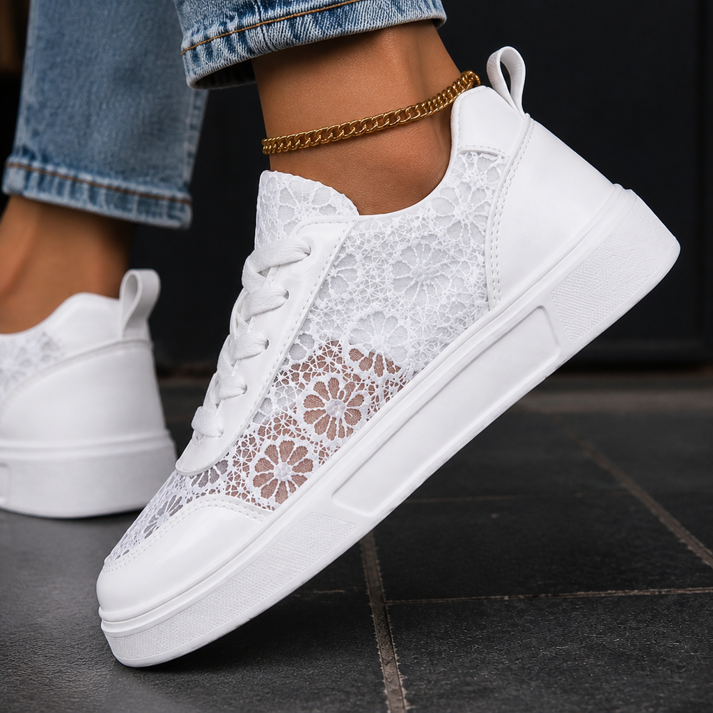 Side view of white low-top lace trainers with sheer floral panels and a platform sole