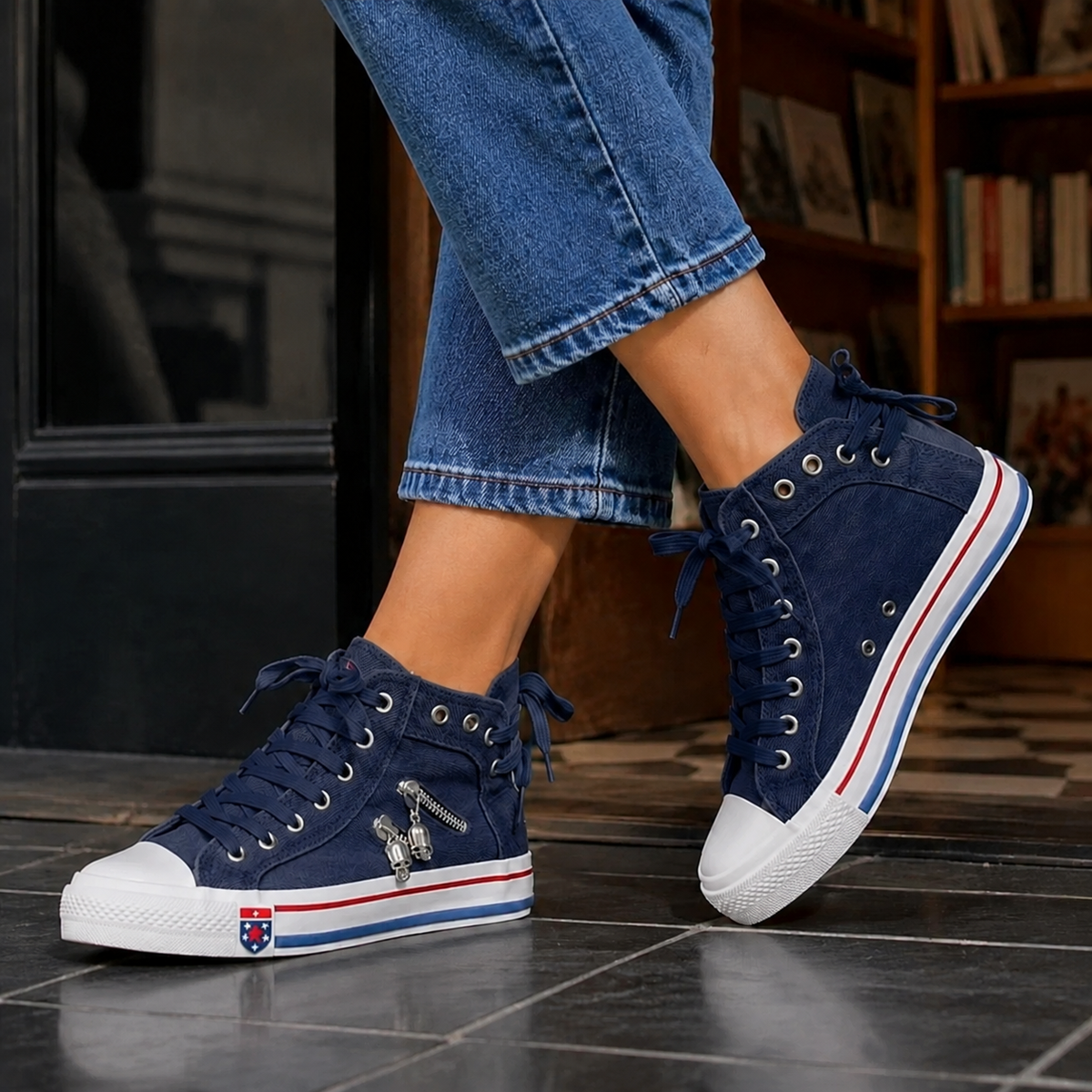 Navy lace-up high top sneakers with flat contrast sole, worn with cropped jeans