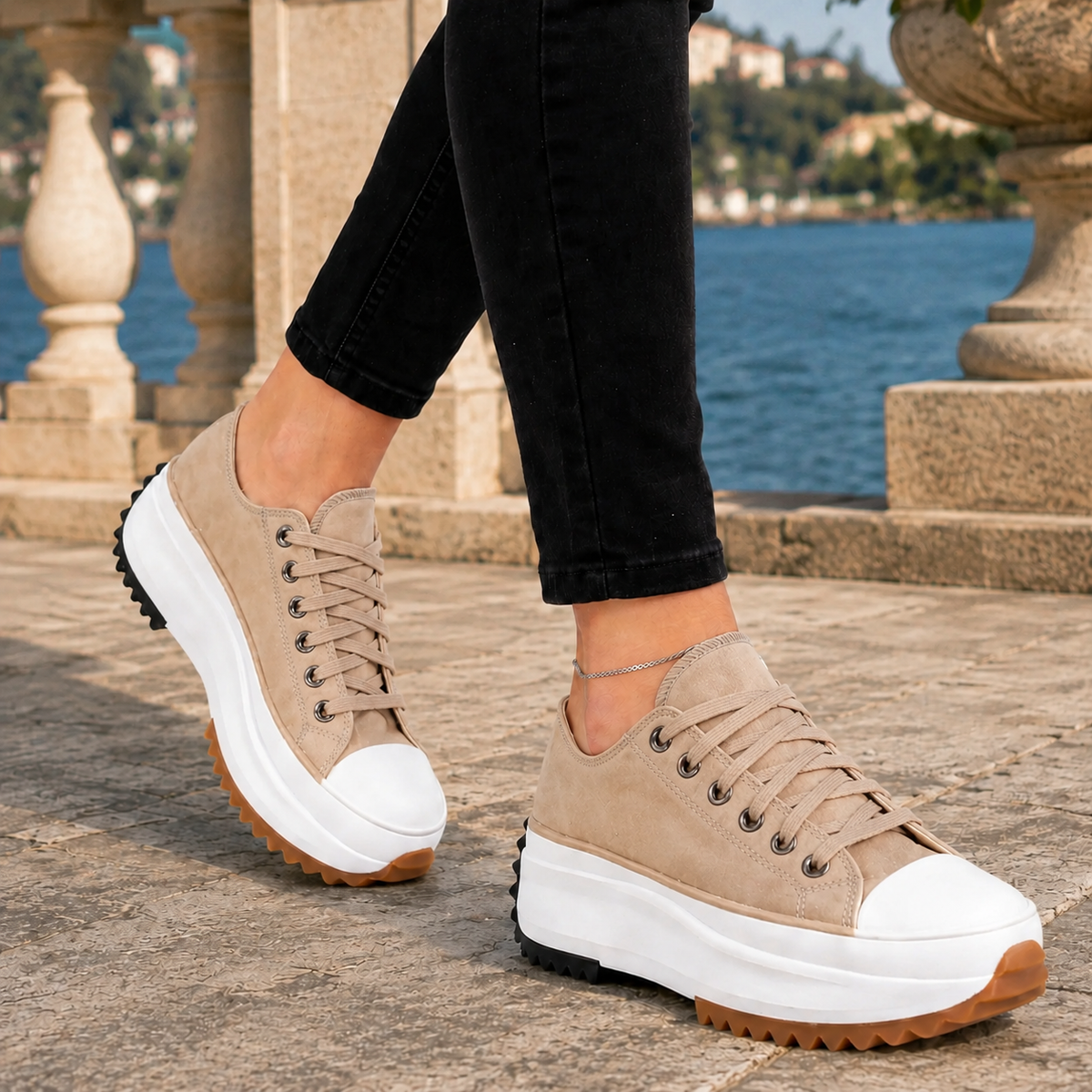 Beige lace-up low-top platform trainers with a reinforced contrast toe cap and chunky platform sole