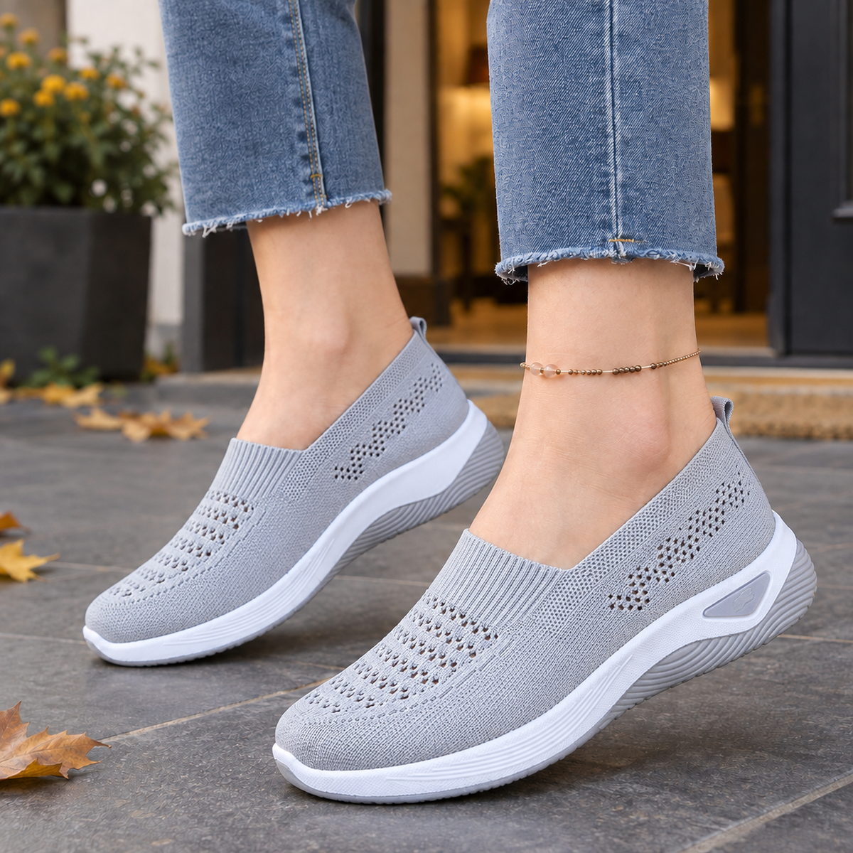 Grey breathable knit slip-on trainers with ventilated panels and a white raised sole