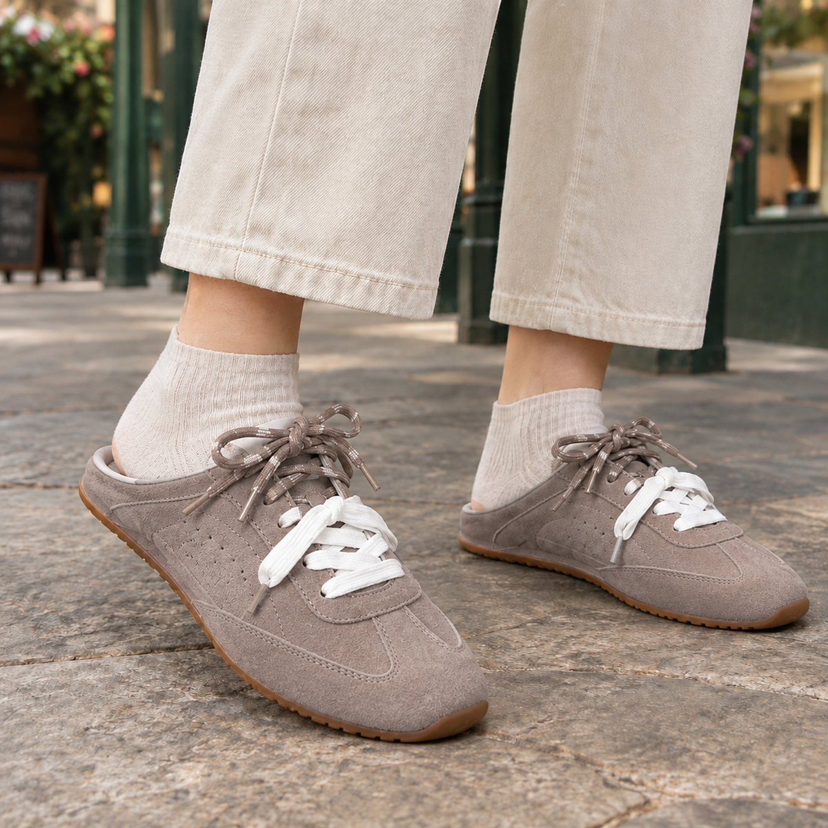 Grey backless trainers for women with an open heel, dual lace detailing and a gum sole