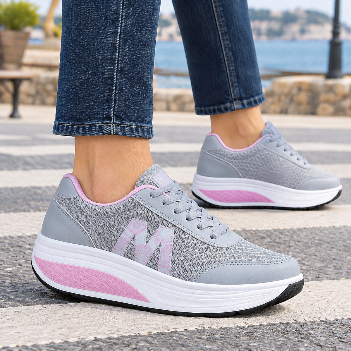 Grey orthopedic sneakers for women with a breathable mesh upper and rocker platform sole.