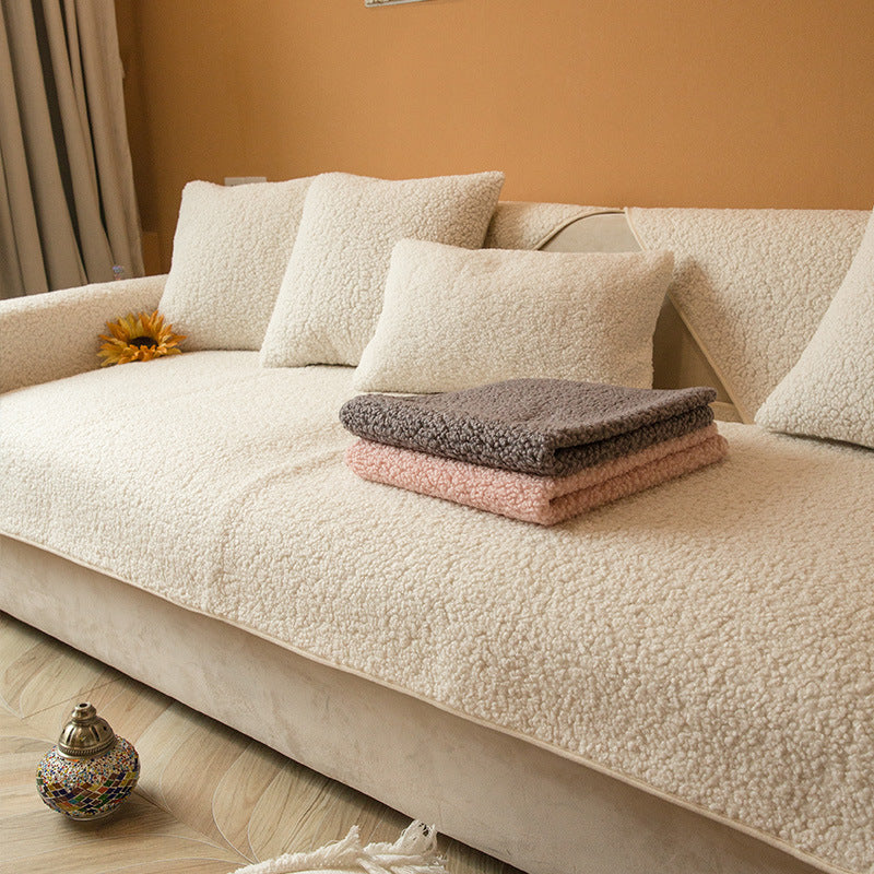 White teddy fabric sofa cover with matching cushion covers on a sofa
