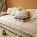 White teddy fabric sofa cover with matching cushion covers on a sofa