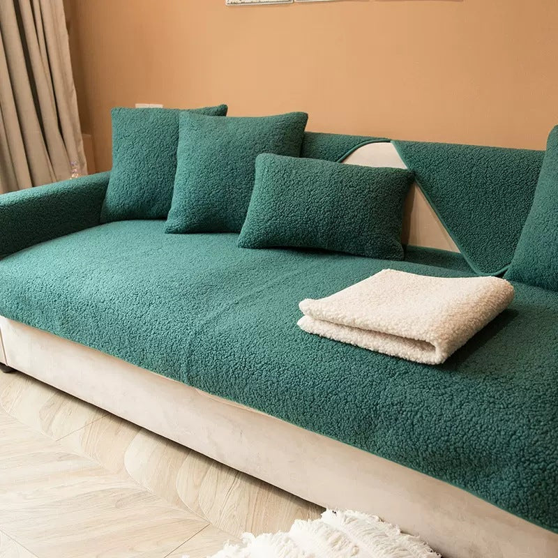 Teal teddy fabric sofa cover with a cream throw on the seat