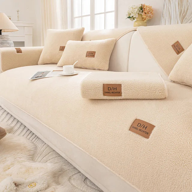 Beige teddy fleece sofa cover with matching cushion covers and a cup on a magazine