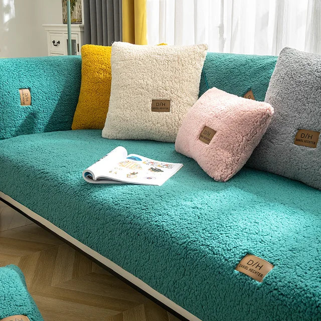 Turquoise teddy fleece sofa cover with soft cushions and an open magazine on the seat