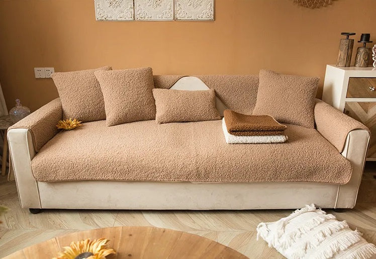 Light brown teddy sofa cover fitted to a full sofa with armrest covers and cushions