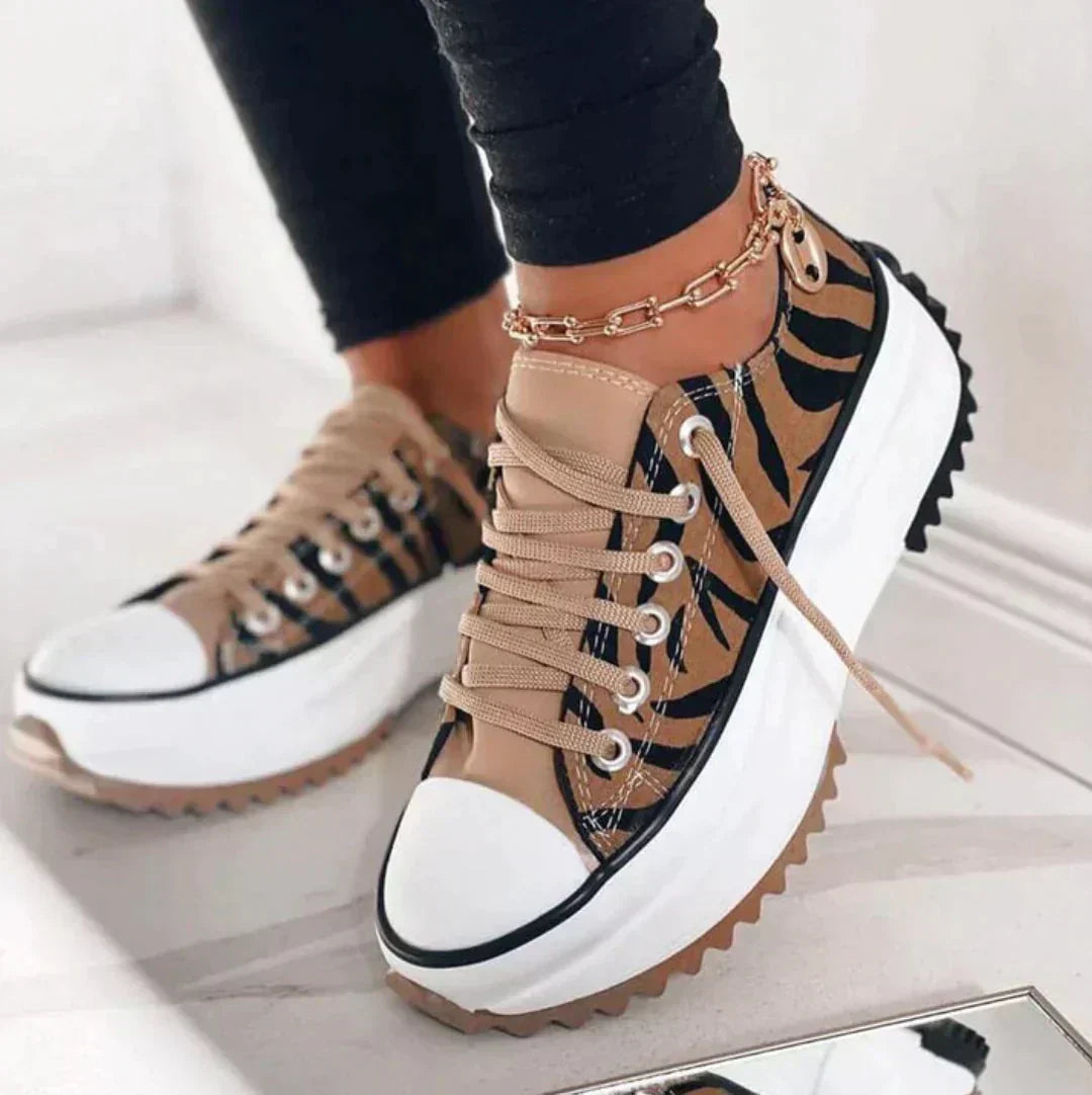 Tiger print platform trainers with a white toe cap and chunky sole